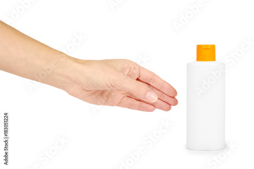 Plastic white shampoo bottle with orange cap in hand isolated on white background. Gel dispenser for hair care. Container with body lotion.