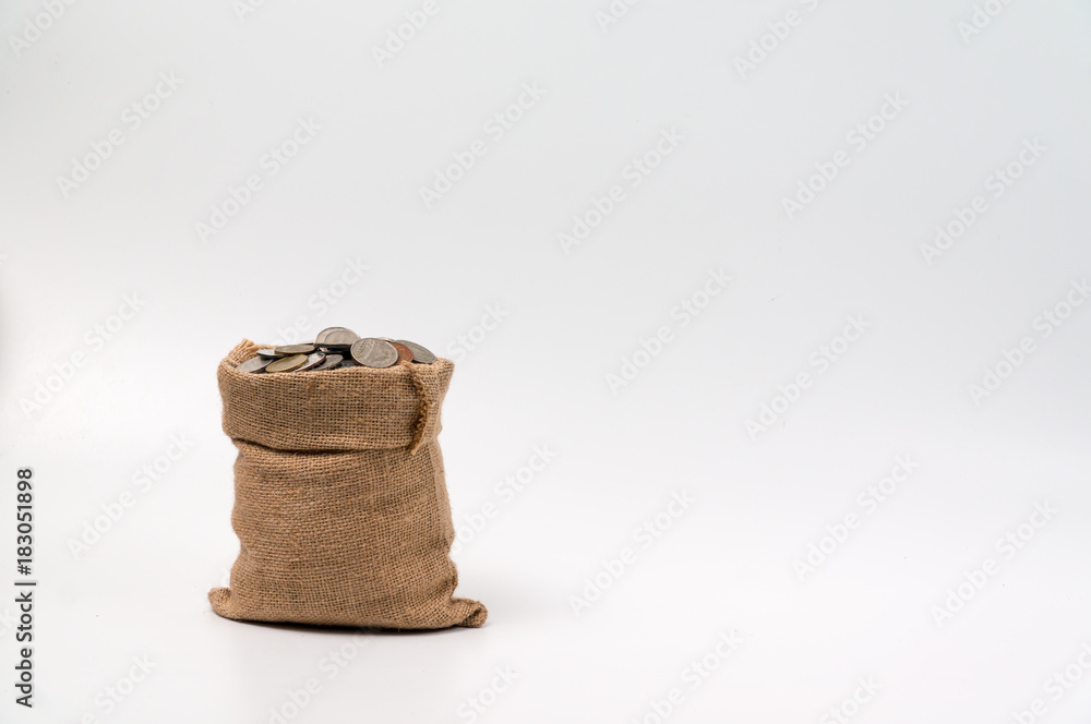 Coins bag made from hemp sack full with coins isolated on white background.