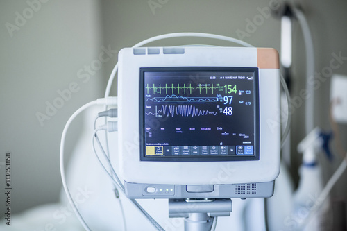 Medical vital signs monitor instrument in a hospital. This health care device displays and monitors heart rate and oxygen levels in hospital patients photo