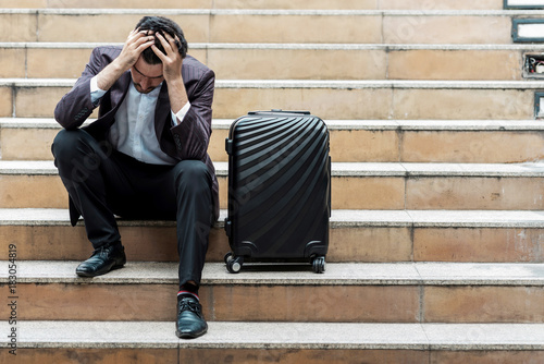 Stress out handsome white male business man or sale man sitting on stair.