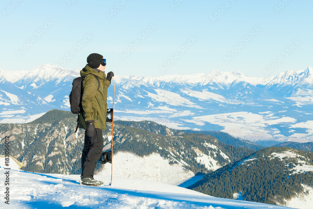 Snowboarder at the top of a mountain