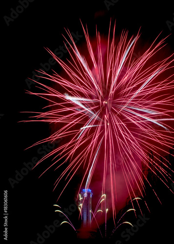 Red fireworks like star with city hall clock