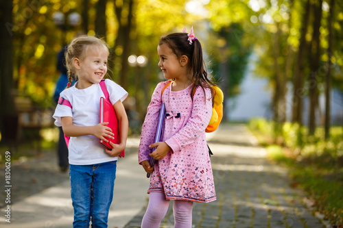 Two little kids going to school together