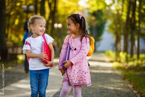 Two little kids going to school together photo