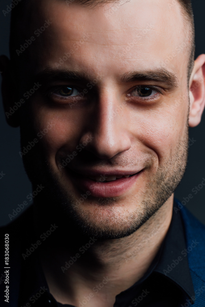 Fototapeta premium Close-up portrait of a attractive handsome man. Good nice guy looks at the frame.