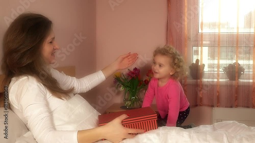 daughter girl give mother woman day birthday present in bed