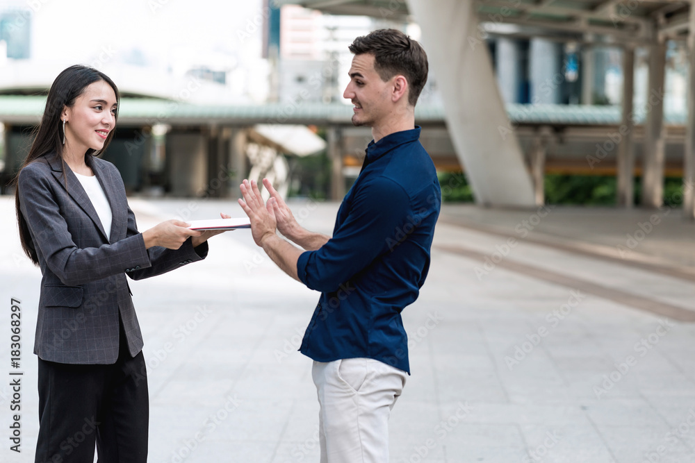 Sale woman trying to sell insurance to potential male client. Sale woman trying to sell insurance to potential male client.