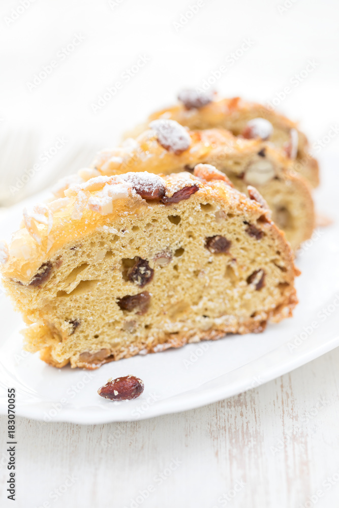 fruit cake with nuts on white dish