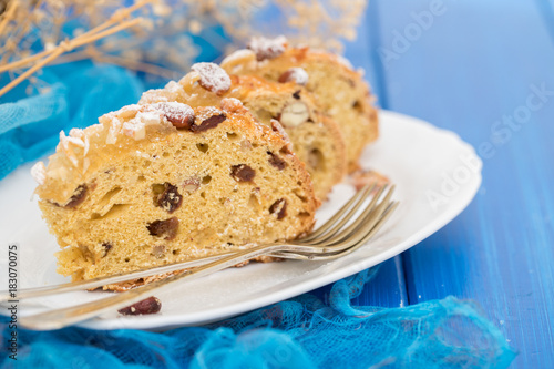 fruit cake with nuts on white dish