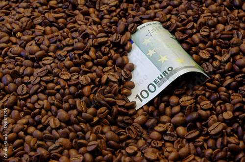 100 Euro banknote in the roasted coffee beans