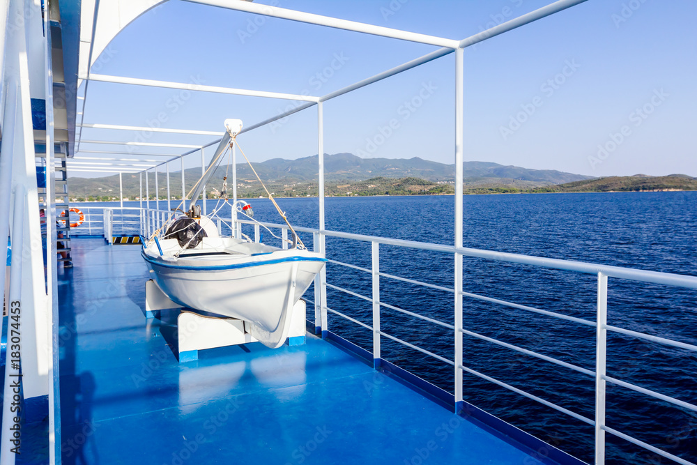 Obraz premium Wooden lifeboat on davits mechanism, rowboat