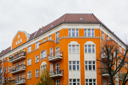orange corner building with grey sky