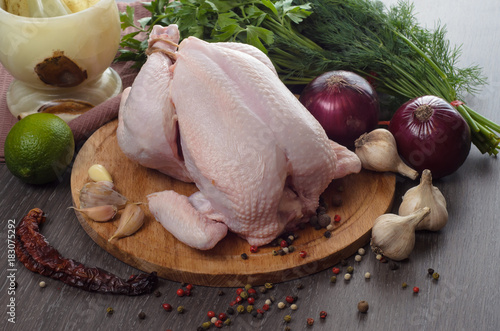 Fresh raw chicken composition on wooden background