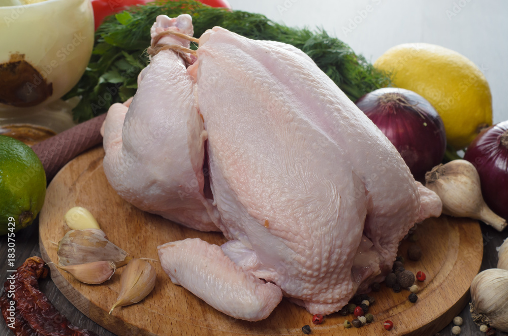 Fresh raw chicken composition on wooden background Fresh raw chicken composition on wooden background