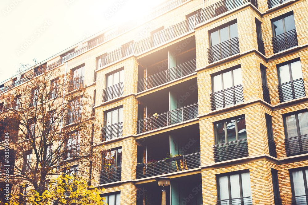 very modern brick apartment building for real estate with sunlight on the top