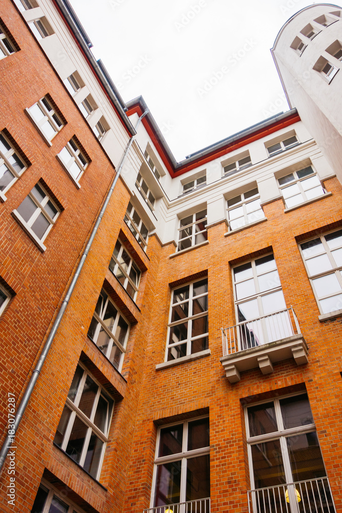 backyard of brick office building with white detailes in the facade backyard of brick office building with white detailes in the facade