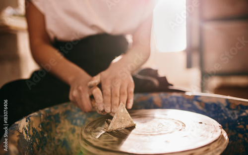 Female potter working on potters wheel