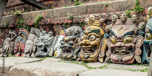 Nepalese traditional demon mask under the wall, Kathmandu, Nepal photo