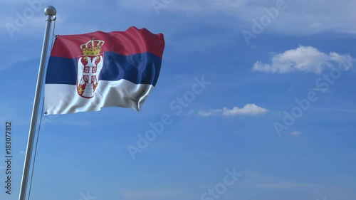 Airplane flying over waving flag of Serbia