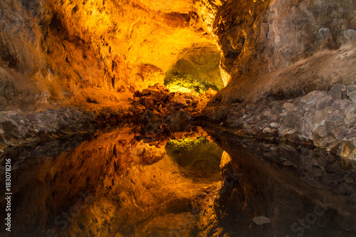 A beautiful reflection inside a cave. warm cave colours reflected inside a pool of water.