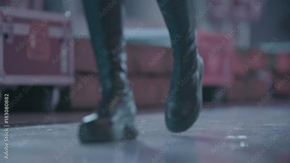 Slow motion shot of thin female legs in jeans and leather boots. Slow motion shot of thin female legs in jeans and leather boots.