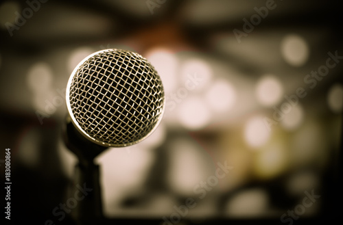 Retro Microphones on front stage in pub bar or restaurant. Classic sing a song in evening and night show concert light bokeh background.