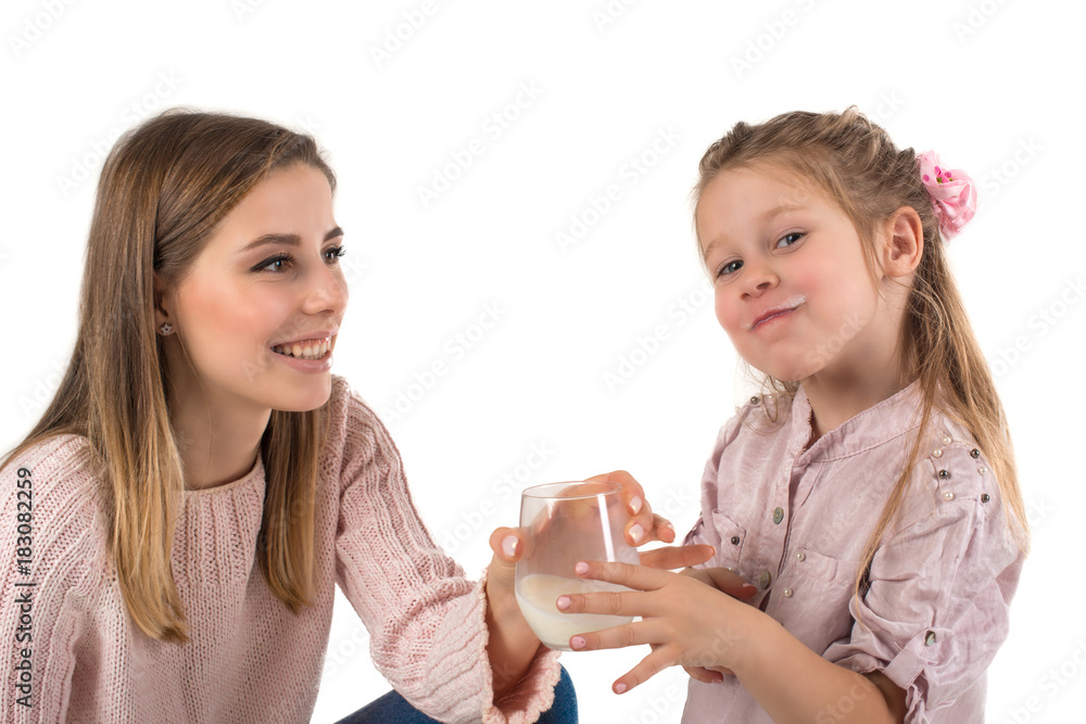 Mother milks to the daughter.The daughter with pleasure drinks milk. Mother milks to the daughter.The daughter with pleasure drinks milk.