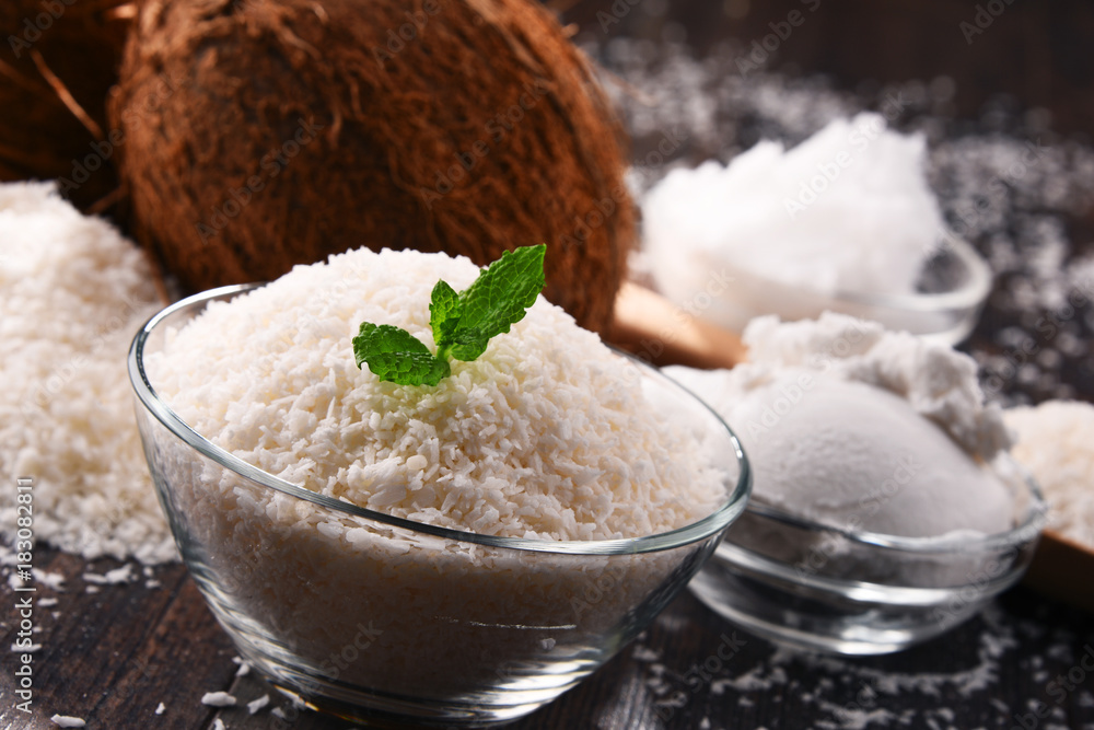 Composition with bowl of shredded coconut and shells Composition with bowl of shredded coconut and shells