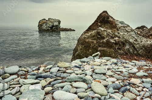 Rock and boulder on the coast of the Aegean Sea in Greece.