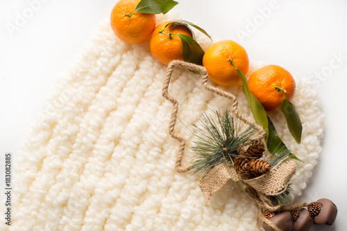 New Year's card with a place for your inscription. Christmas tree, white scarf, mandarins photo