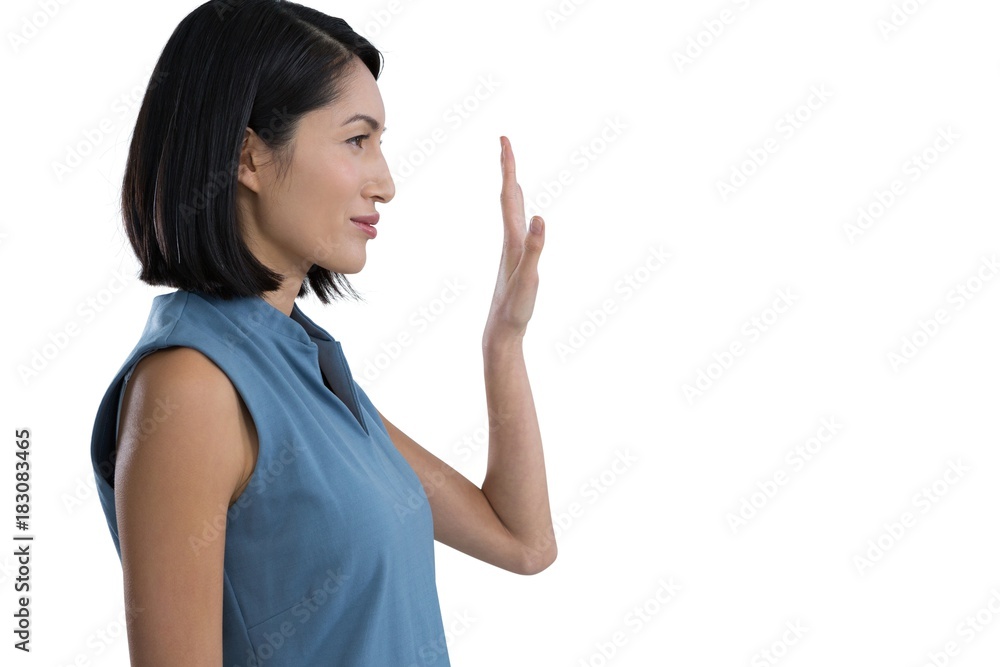 Female executive touching invisible screen Female executive touching invisible screen