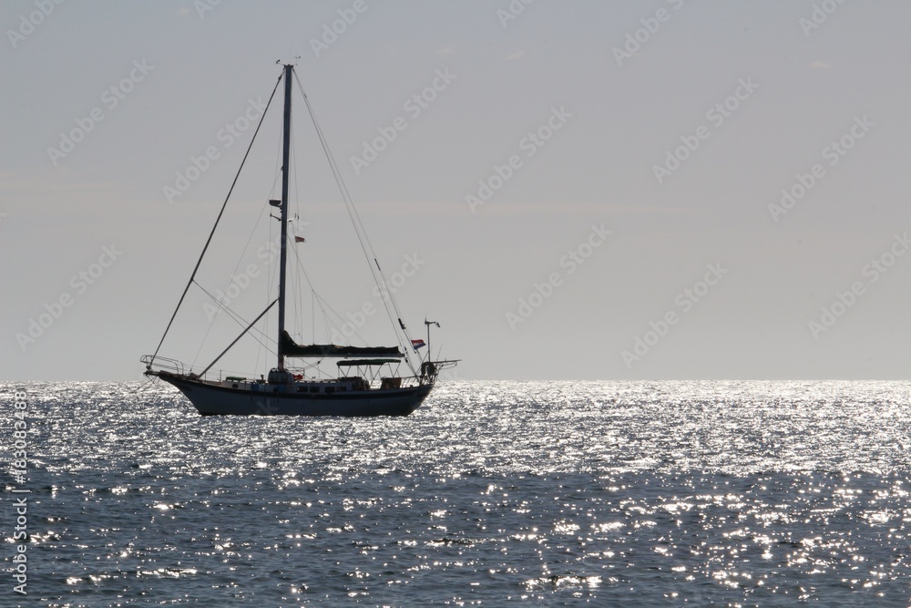 Sailing boat on the atlantic ocean in backlight