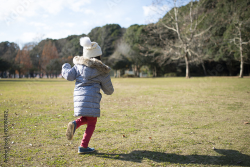 Little girl running in the park photo