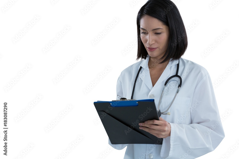 Female doctor writing prescription on clipboard Female doctor writing prescription on clipboard