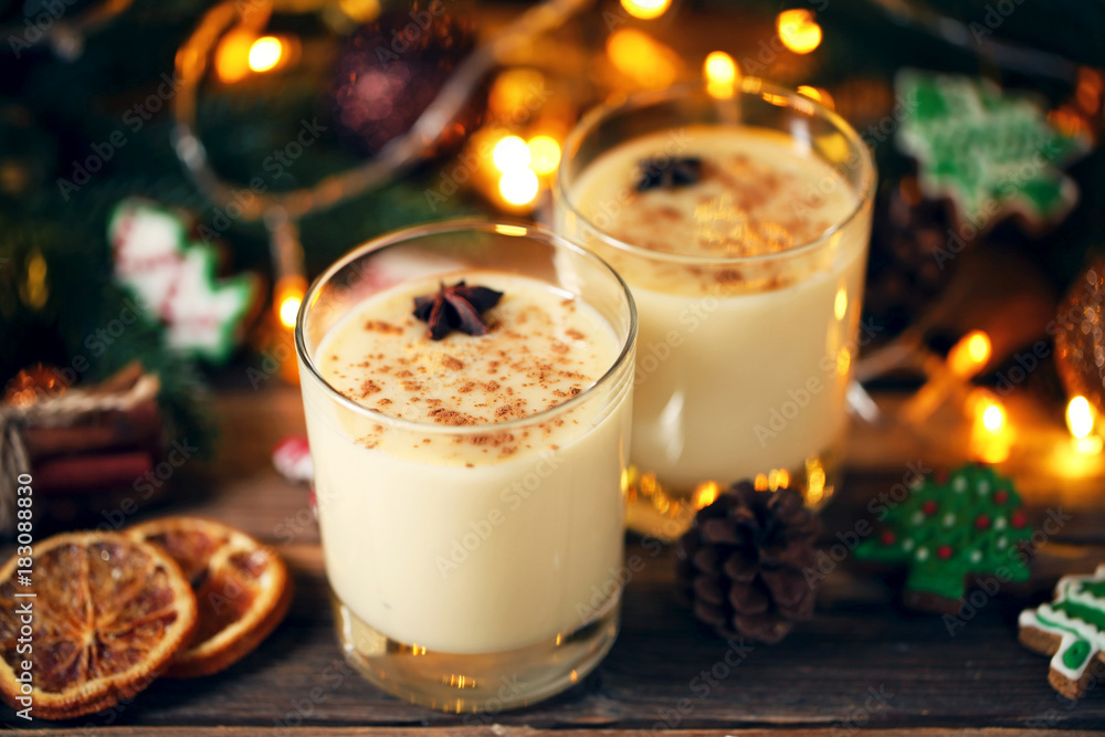 Eggnog in glasses with star anise on wooden table Eggnog in glasses with star anise on wooden table