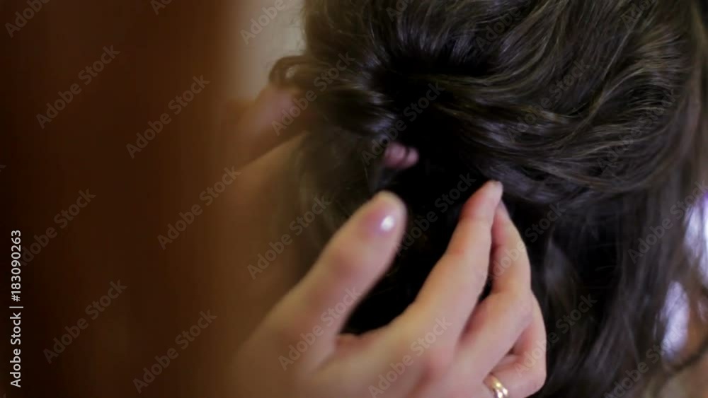dark haired young woman does a hairdress in a hairdresser.close up. stylist makes woman's hairdress in an art salon. dark haired young woman does a hairdress in a hairdresser.close up. stylist makes woman's hairdress in an art salon.