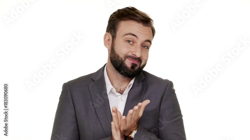 Portrait of cunning man in suit gesturing with both hands meaning oops sorry pretending he has no idea what happened or he do nothing over white background. Concept of emotions