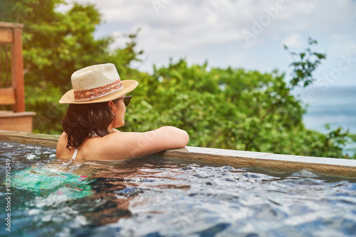 Young woman in bikini staying in pool
