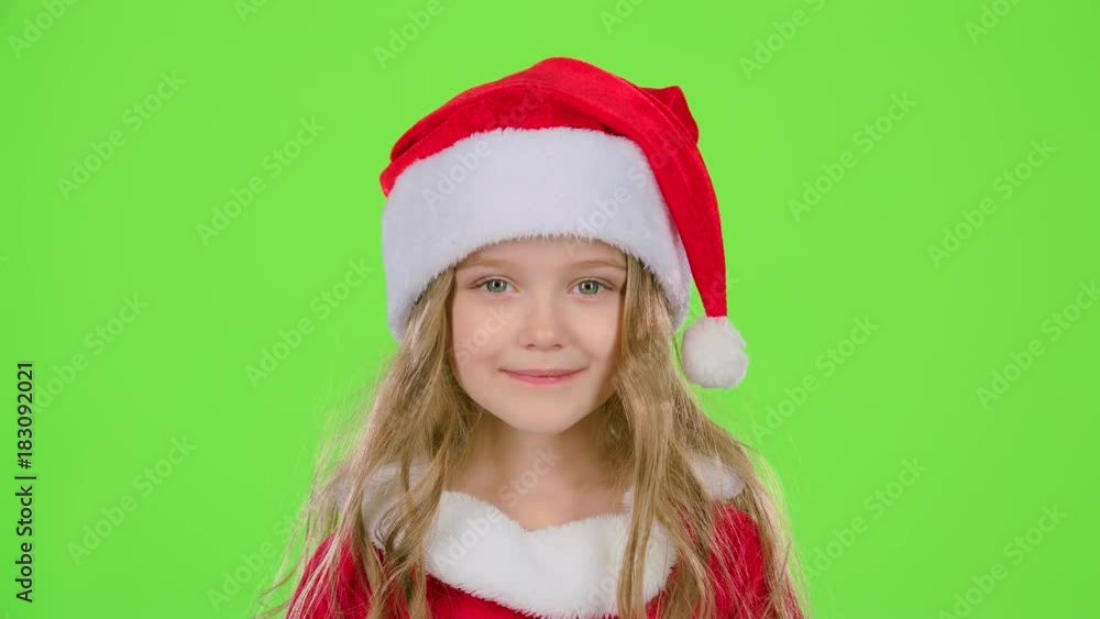 Baby in a beautiful suit and a red New Year's cap smiles. Green screen. Slow motion Baby in a beautiful suit and a red New Year's cap smiles. Green screen. Slow motion