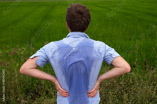 Photography Man with hyperhidrosis sweating very badly under armpit in blue shirt, isolated