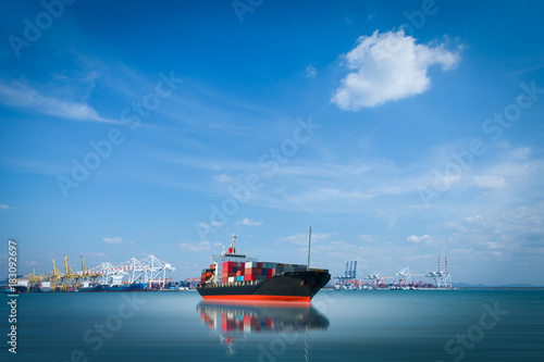ship with container on blue sky background