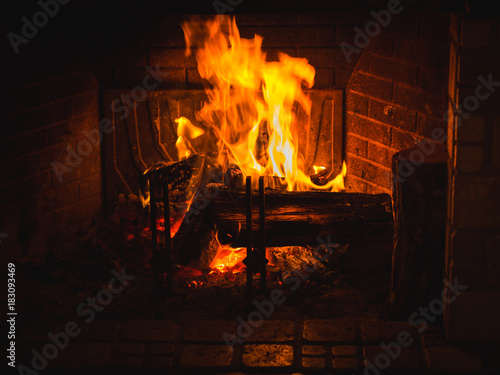 Burning wood in fireplace in a countryside house