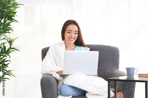 Young woman using laptop wh...