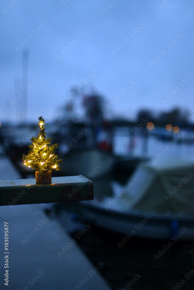 A little christmas tree in a port with ships and boats Stock Photo ...