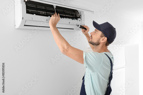 Male technician repairing a...
