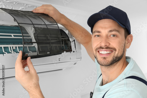 Male technician cleaning ai...