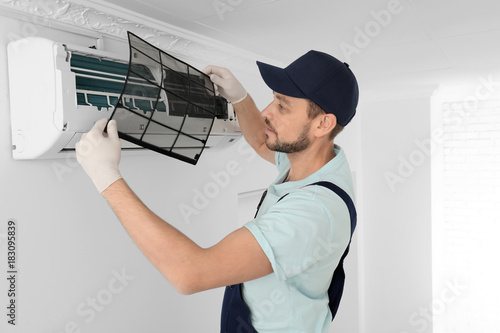 Male technician cleaning ai...