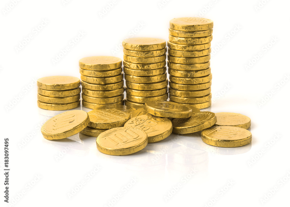 Golden coin stacks on a white Golden coin stacks on a white