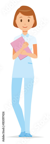 A female nurse wearing a white uniform standing with a file