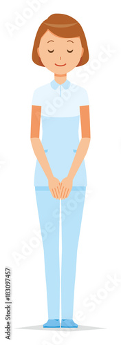 A female nurse wearing a white uniform bows